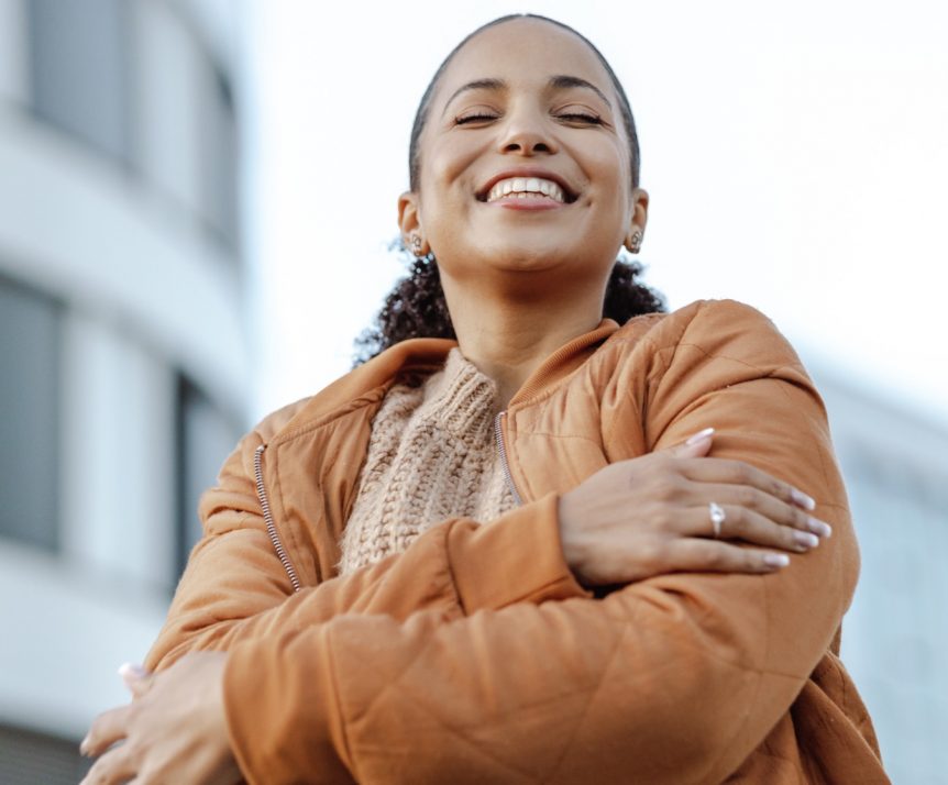 A therapist hugs herself, practicing self compassion